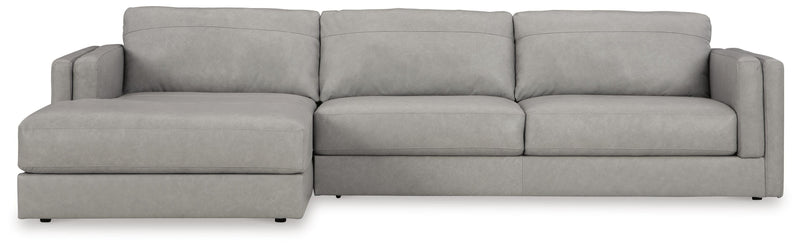 Ashley Furniture Amiata sectional with chaise, showing beige fabric upholstery and plush seating with a modern design.