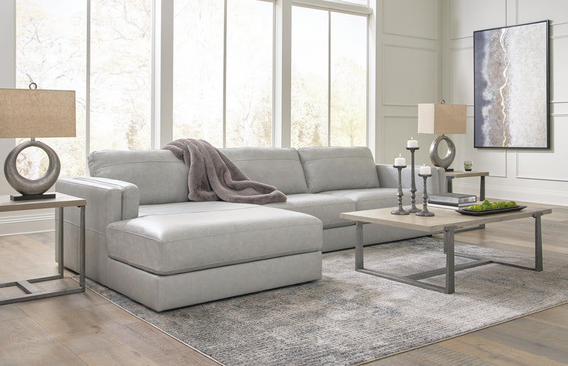 Ashley Furniture Amiata sectional with chaise, featuring plush cushions and contemporary design in a neutral fabric.