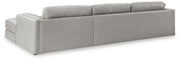 Ashley Furniture Amiata sectional with chaise, showing the back view of the beige fabric sofa and chaise lounge in a modern living room.