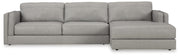 Ashley Furniture Amiata sectional with chaise, showing beige fabric upholstery and plush cushions in a modern living room setting.