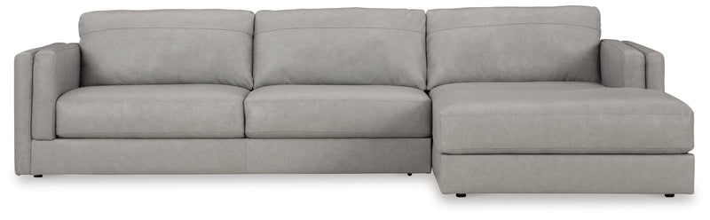 Ashley Furniture Amiata sectional with chaise, showing beige fabric upholstery and plush cushions in a modern living room setting.