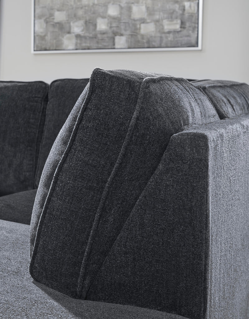 Ashley Furniture Altari Sleeper Sectional with Chaise, showing close-up of fabric, chaise lounge, and sofa details in a modern living room.