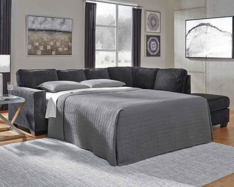 Ashley Furniture Altari sleeper sectional with chaise in neutral fabric, featuring plush cushions and modern design.
