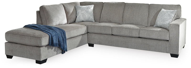 Ashley Furniture Altari Sleeper Sectional with Chaise showing fabric upholstery and plush cushions in a modern living room setting.