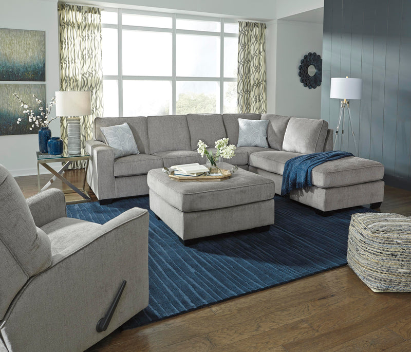 Ashley Furniture Altari Sleeper Sectional with chaise showing plush fabric upholstery and a spacious seating area.