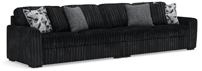 Ashley Furniture Midnight-Madness sectional sofa with plush cushions and modern design, shown in a cozy living room setting.