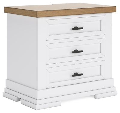 Ashley Furniture Ashbryn Nightstand with wood finish, angled design, and drawer storage, shown from a side angle.