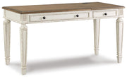 Ashley Furniture Realyn Home Office Set with desk, chair, and storage, shown from an angled view in a modern home office setting.