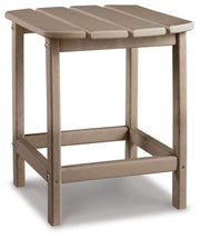 Outdoor table set by Ashley Furniture featuring a spacious table and comfortable chairs in a backyard setting.