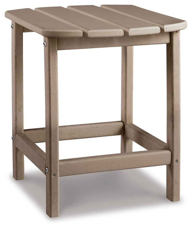 Outdoor table set by Ashley Furniture featuring a spacious table and comfortable chairs in a backyard setting.