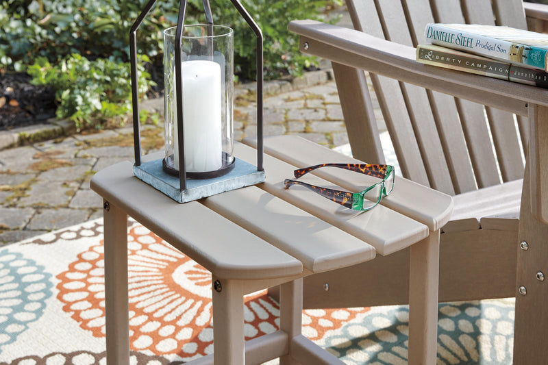 Ashley Furniture Sundown Treasure outdoor seating set featuring a table and chairs with woven detailing and plush cushions.