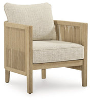 Two Ashley Furniture Spooners Cove outdoor lounge chairs with cushions, featuring woven design and armrests, suitable for patio relaxation.