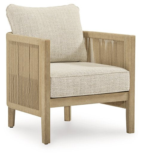 Two Ashley Furniture Spooners Cove outdoor lounge chairs with cushions, featuring woven design and armrests, suitable for patio relaxation.