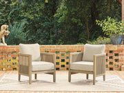 Set of two Ashley Furniture Spooners Cove outdoor lounge chairs with cushions, featuring woven rattan and sturdy metal frames.