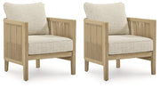 Set of two Ashley Furniture Spooners Cove outdoor lounge chairs with cushions, featuring a stylish, comfortable design for outdoor relaxation.