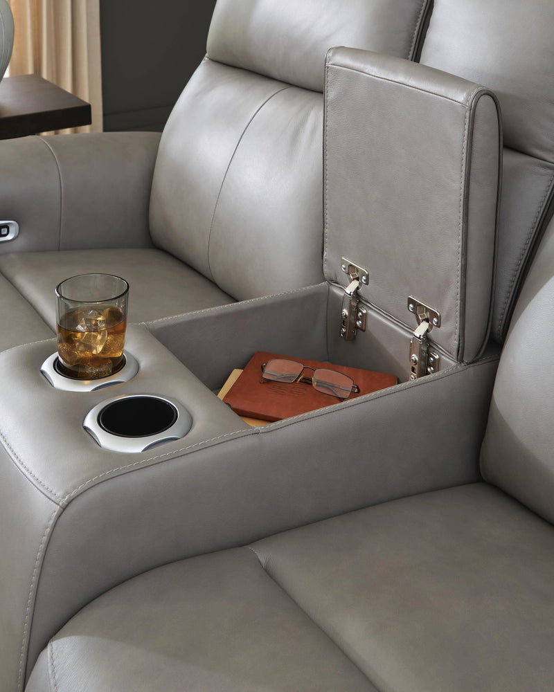 Ashley Furniture 5Z-Comfort Power Reclining Living Room Set with plush cushions and dark upholstery, featuring a sofa and recliner.